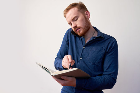 Businessman writing in planner