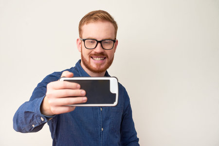 Cheerful man taking selfie