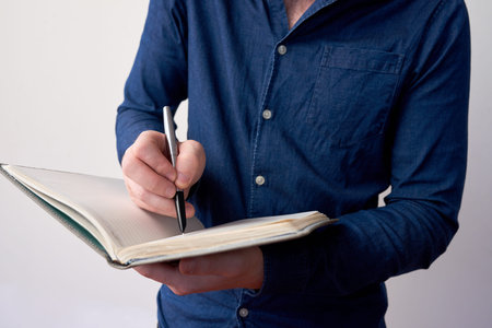 Businessman writing in planner