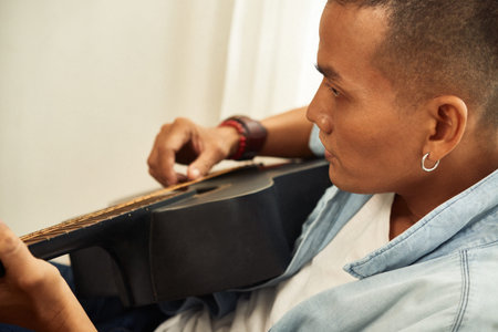 Serious man playing guitar