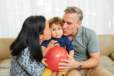 Parent hugging and kissing son