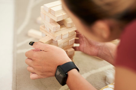 Hands of woman pulling wooden block out of towel she made