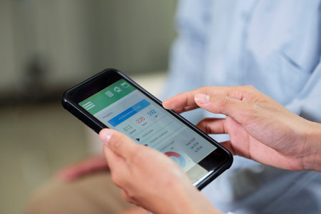 Close-up of woman using her smartphone she sitting and looking at results of her health in  mobile...
