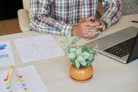 Cropped image of financial manager working with documents at his office tableの写真素材