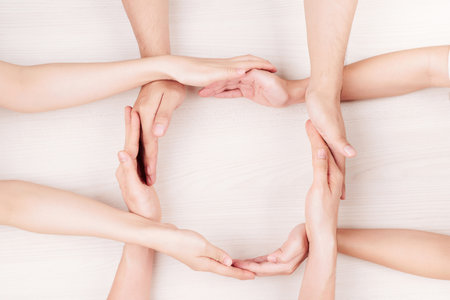 Close-up of large group of young people making square from hands togetherの写真素材