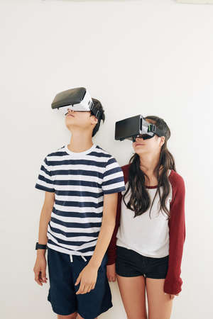 Smiling teen brother and sister testing virtusl reality applicationの写真素材