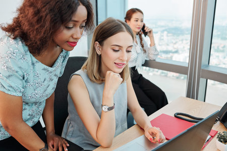 Pretty businesswomen reading e-mail with feedback from client on laptop screen