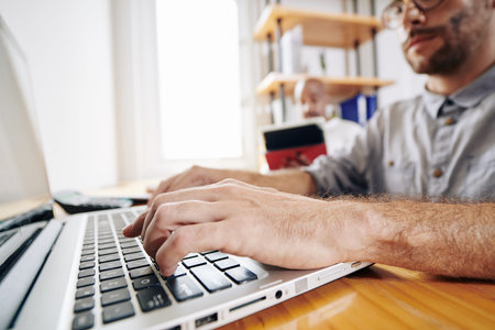Hands of professional frond end developer programming and working on new website for a big company