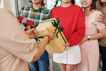 Cropped image of senior woman accepting Christmas present from her familyの写真素材