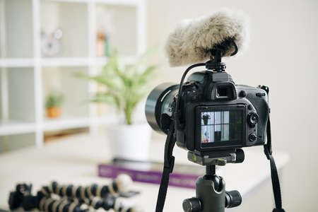 Professinal digital camera with fluffy microphone cover in office of bloggerの写真素材