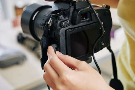 Close-up image of blogger plugging in microphone in digital camera before shootingの写真素材
