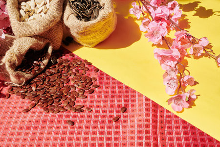 Table served for Tet celebration with blooming peach branches and sacks with watermelon, sunflower...