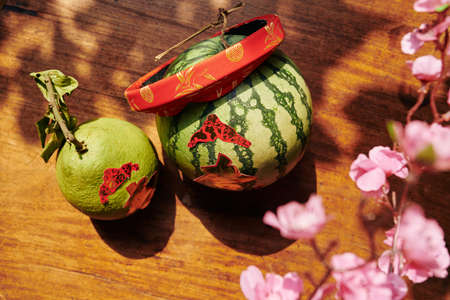 Watermelon and pomelo with stickers decorated for Chinese New Year celebrationの写真素材