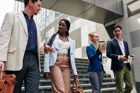 Business people talking and discussing news when walking in the street
