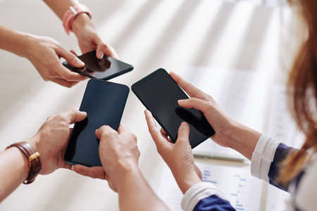 Group of business people using applications on smartphones for communicationの写真素材