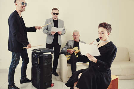 Music band practicing new song at rehearsal in studioの写真素材