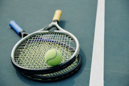 Two tennis rackets and ball on outdoor court, selective focusの写真素材