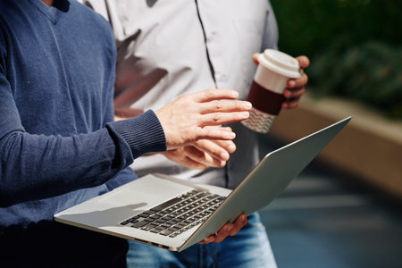 Cropped image of product manager showing presentation to colleague and explaining his new idea
