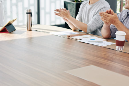 Cropped image of business people clapping to speaker at conference after discussing financial issues