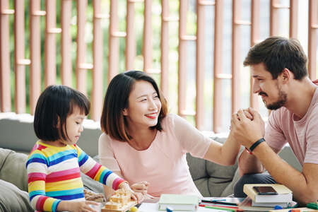 Happy young man enjoying spending time with his wife and daughterの写真素材