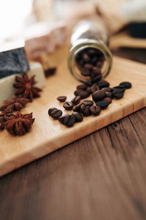 Coffee beans and anise flowers on cutting board prepared for soap makingの写真素材