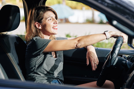 Beautiful positive young woman enjoying riding truck in the city