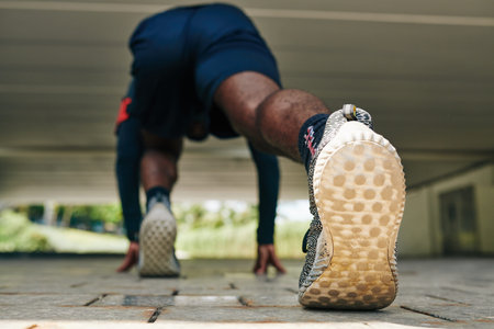 Sportsman getting ready to start running, focus on shoe sole