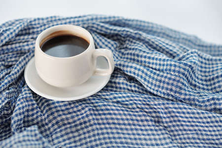 Cup of tasty strong morning coffee on cotton table clothの写真素材