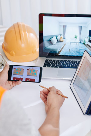 Interior designer remodeling house of customers and working on blueprint of project