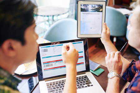 Friends buying plane tickets and booking hotel for summer vacation