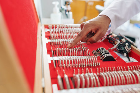 Close-up image of ophthalmologist choosing correct lenses from big set for trial framesの写真素材