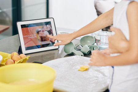 Woman following video tutorial when trying new cake recipe at home