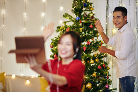Man waving to video calling relative