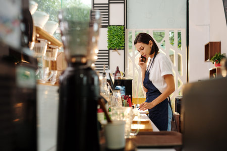 Coffeeshop manager talking on phone