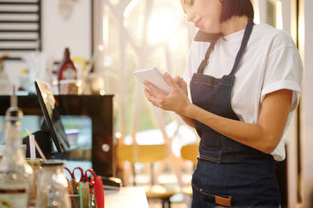 Waitress accepting order on phoneの写真素材