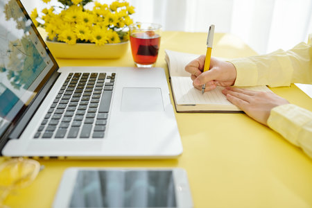 Businesswoman writing in planner