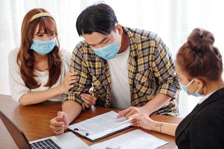 Couple reading rental lease agreementの写真素材