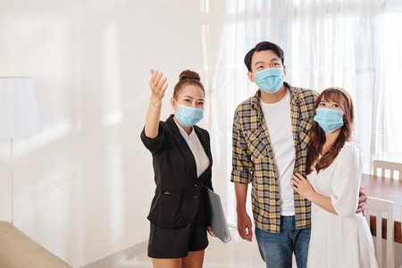 Showing house to young couple