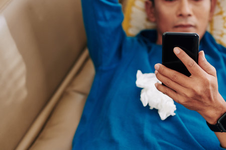 Man with running nose resting on sofa
