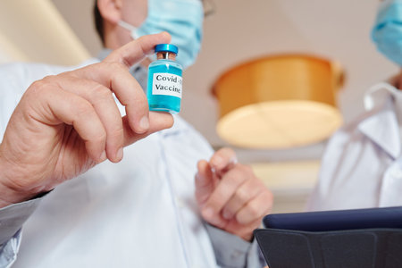 Researcher showing vial with vaccine