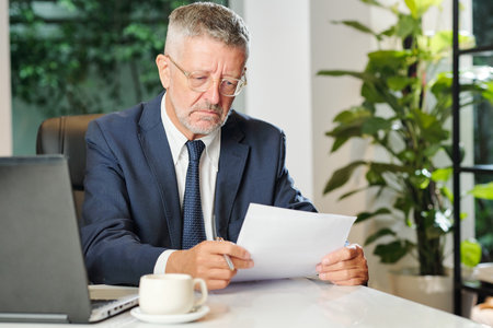 Business executive reading contractの写真素材