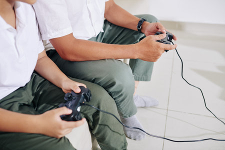 Playing videogame with fatherの写真素材