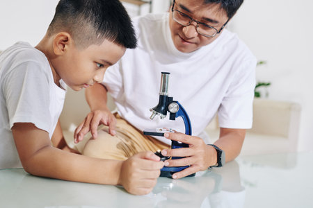 Showing microscope to sonの写真素材