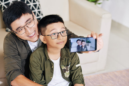 Father and son taking selfie
