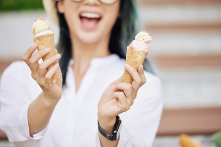 Woman showing ice-cream conesの写真素材