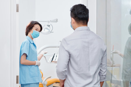 Dental nurse inviting patientの写真素材