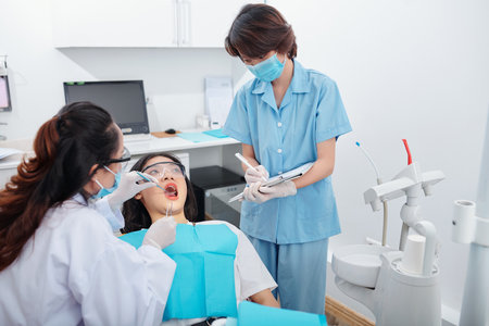 Dentist checking teeth of patientの写真素材