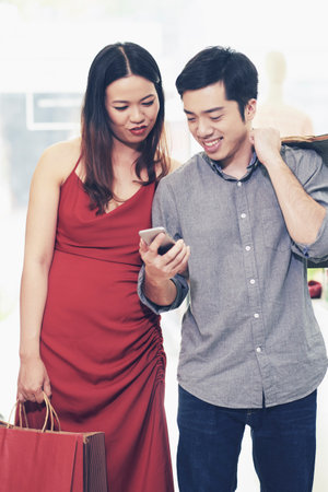 Couple reading notification on phoneの写真素材
