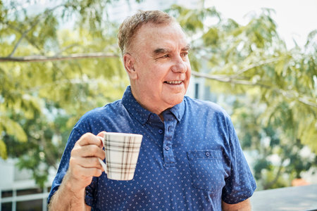 Positive man with cup of coffee