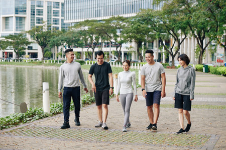 Young Vietnamese people walking in parkの写真素材